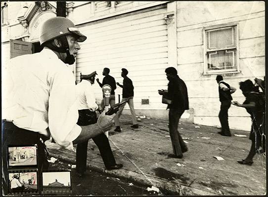 Police officers in riot gear drawing their guns on residents in the 1966 Bayview-Hunters Point riots in front of South San Francisco Opera House AAK-1649.jpg