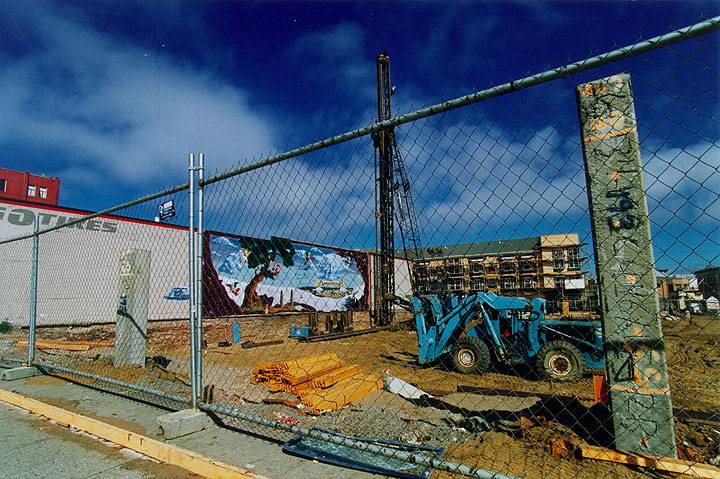 Caen-mural-behind-chainlink-fence-on-Big-O-tires.jpg