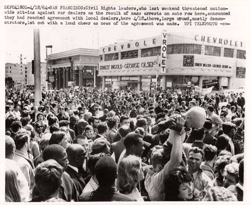 Crowd cheering settlement with auto dealers 1964 AAK-0884.jpg
