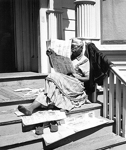 File:Woman-reading-newspaper-on-steps.jpg