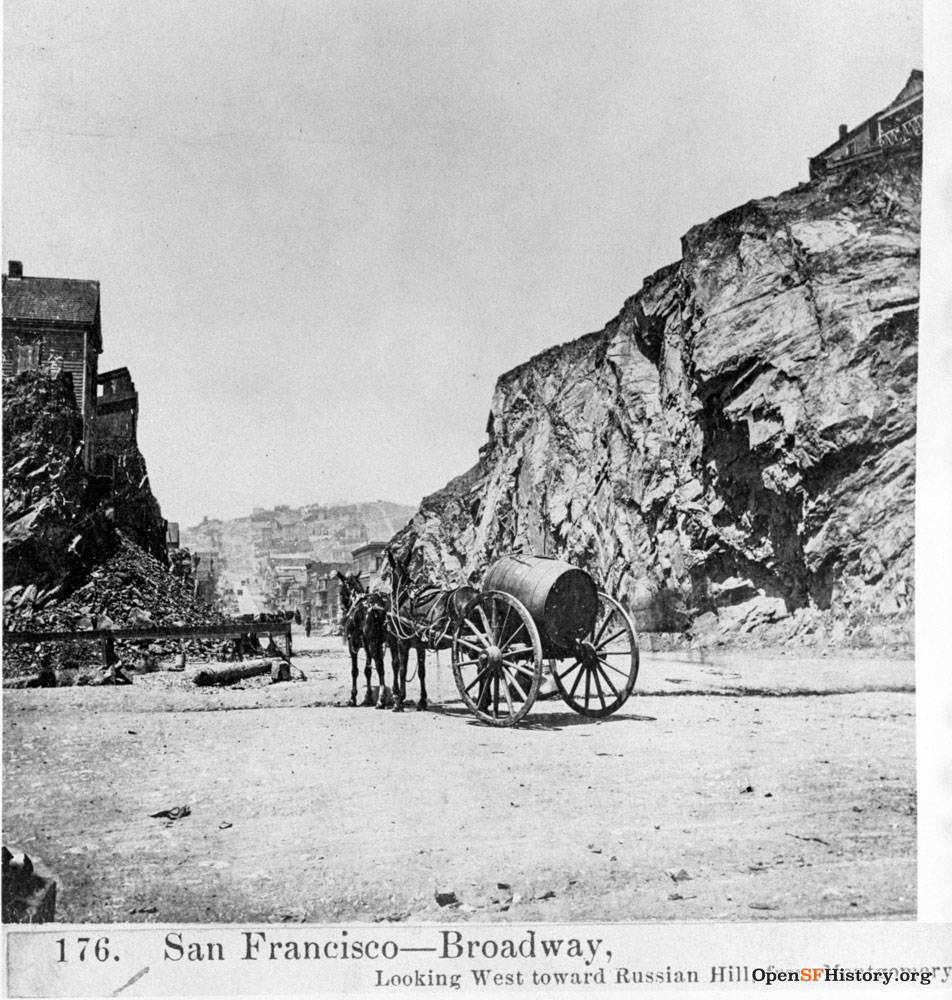 Broadway,-Looking-West-toward-Russian-Hill,-from-Montgomery-View-west-from-Telegraph-Hill-at-Kearny,-with-horse-hitched-to-water-wagon.-Homes-visible-on-each-side-of-rock-cut. wnp37.jpg