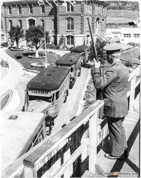 File:Prison buses leaving jail, guard with rifle watching. Ingleside Jail closed 8 July 1934. Prisoners were transferred under heavy guard to new county jail at San Bruno. Judson hillside in right background wnp4.1206.jpg