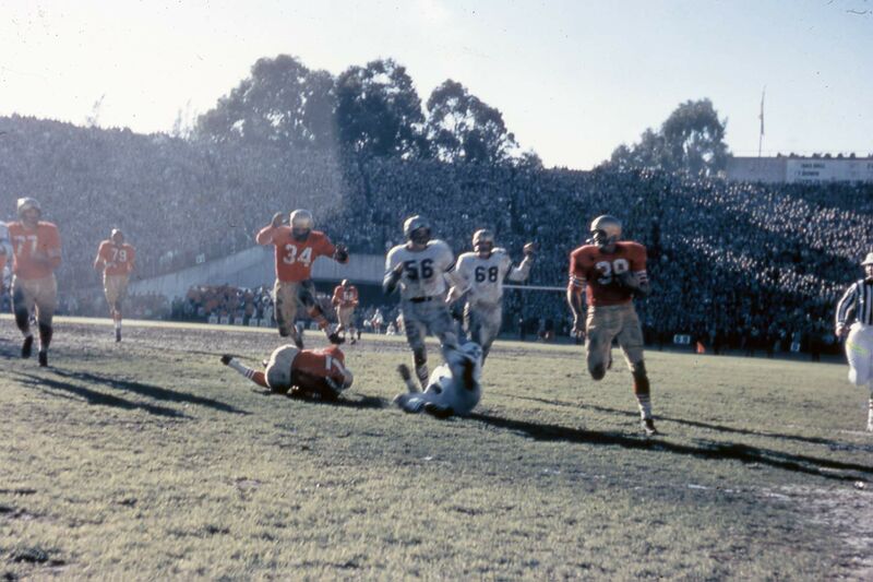 File:49ers v Lions 1957 Joe Perry 34, jumping a teammate and Bob St. Clair 79 in background.jpg