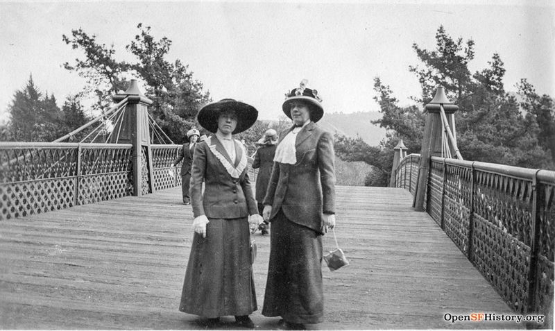 Ggp c 1915 View North toward Mt. Sutro. Two women posing on Roebling steel pedestrian bridge over Middle Drive (now Nancy Pelosi Drive) wnp27.7029.jpg