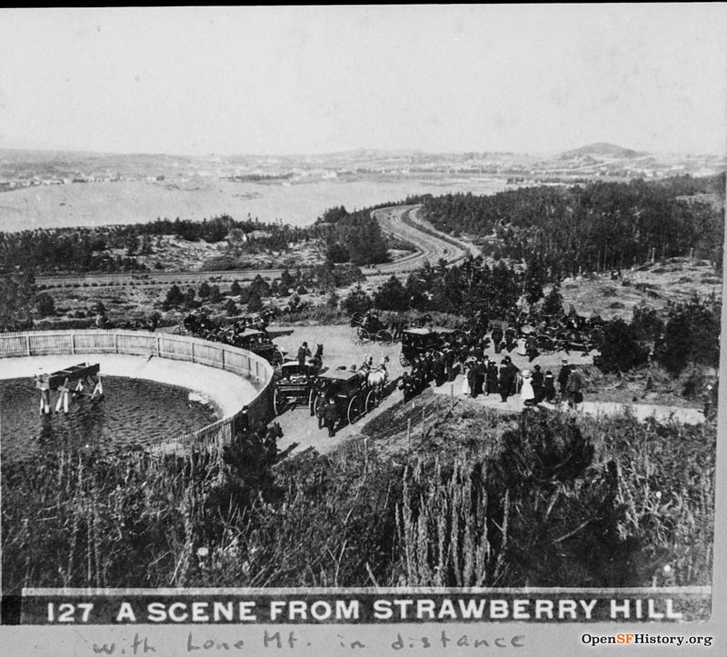 View northeast from Strawberry Hill c 1870 Lone Mountain in the distance at top right, Reservoir, people with horses and carriages, North now JFK Drive curving at center with Richmond District sand dunes beyond wnp37.00575.jpg
