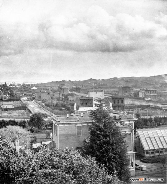File:East view from Woodwards c 1869 Woodward's Gardens, elevated view east across Mission District to Potrero Hill showing rear of museum and conservatory. Erie Street on other side of Mission wnp26.639.jpg