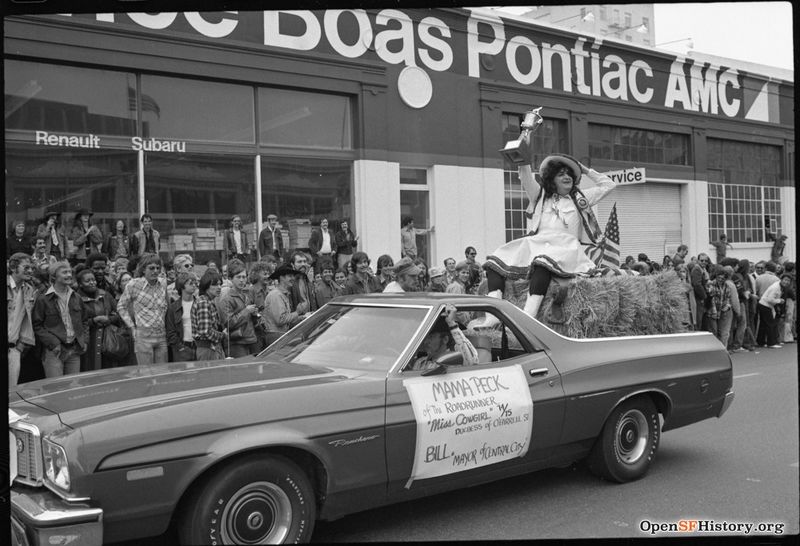 File:Gay Freedom Day Trophy-bearing individual on hay bale in automobile during Gay Freedom Day parade. Sign reads- Mama Peck of the Roadrunner- Miss Cowgirl 74-75, Duchess of OFarrell St. Bill, Mayor of Central City wnp72.103.jpg